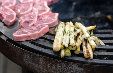 meat and asparagus on the bbq in the summer