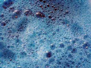 Foam of blue color bath bomb in water