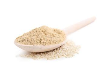 Wooden spoon with sesame flour isolated on white
