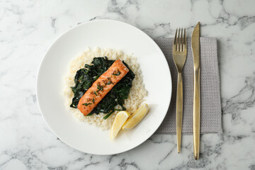 Tasty salmon with rice and spinach served on white marble table, flat lay
