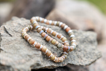 Two bracelets made of natural jasper stones beads. Handmade jewelry. Woman exoteric accessories. Talismans and amulets. Selective focus