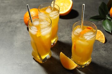 Delicious orange soda water on grey table