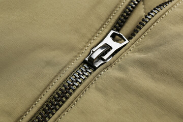 Grey jacket with zipper as background, closeup view