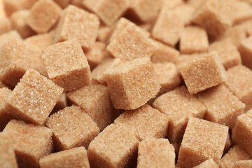 Brown sugar cubes as background, closeup view