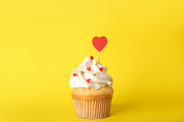 Tasty cupcake for Valentine's Day on yellow background