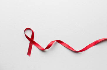 Obraz na płótnie Canvas Red awareness ribbon on white background, top view with space for text. World AIDS disease day
