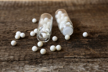 Bottles of homeopathic remedy on wooden table