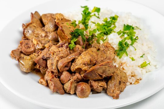 Close up of braised chicken liver with hearts and boiled rice