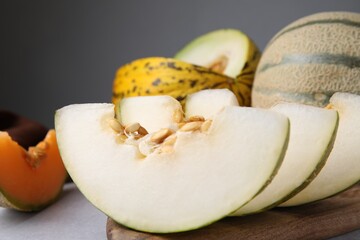 Tasty colorful ripe melons on table, closeup