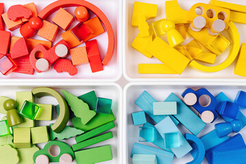 Educational games for Colors sorting. Red, yellow, green and blue wooden blocks in boxes. Colors...
