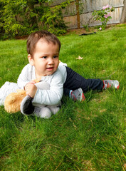 Boy Resting on Pile of Plush Toys