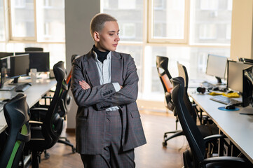 Business woman with short haircut in empty office. 