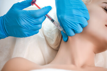 Plastic Surgery Concepts. Closeup Beautician Hands Doing Facial Skin Lifting Injection To Woman's...