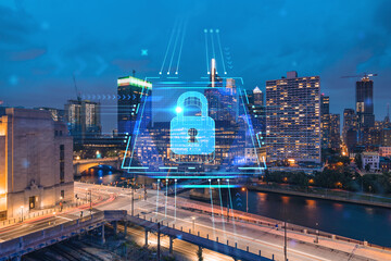 Fototapeta premium Aerial panoramic cityscape of Philadelphia financial downtown at night time, Pennsylvania, USA. Glowing Padlock hologram. The concept of cyber security to protect companies confidential information