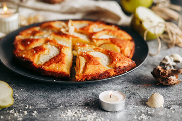 Cake with pear, honey and almonds. Delicious pie on a concrete table