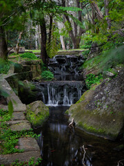 Fototapeta na wymiar Multi-tiered waterfall cascade in small creek.