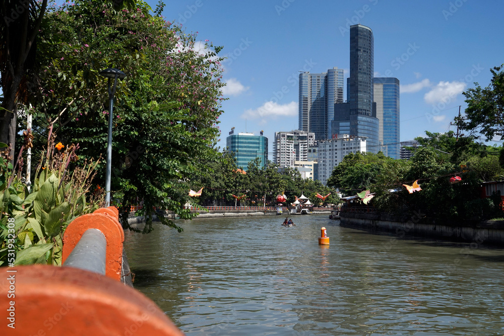 Wall mural surabaya, august 04, 2022. kalimas river in surabaya city, indonesia with buildings and blue sky on 