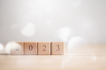 2023 New year concept. Wooden cube block with text 2023 on table with copy space..Start new year...