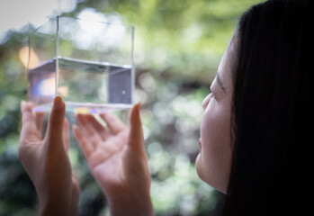 Close up woman holding cube with water