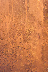 Frosty patterns on the glass, the dawn sun through the frost, yellow vertical abstract winter background