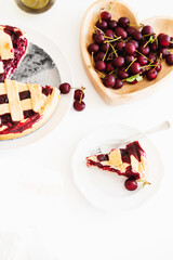 Plate with tasty American cherry pie on white background. Top view. Copy space