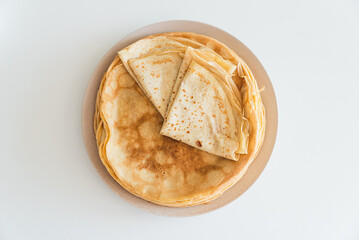 Stack of French crepes  on white table. Top view