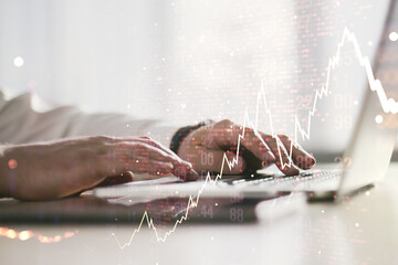 Double exposure of abstract creative financial diagram with world map and with hands typing on computer keyboard on background, banking and accounting concept