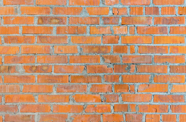 Wall in a new building made of red brick, construction texture