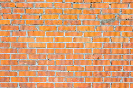 Wall in a new building made of red brick, construction texture