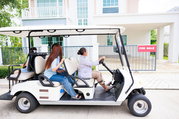 Elder sale agency driving golf cart  present new house to family for sell real estate.