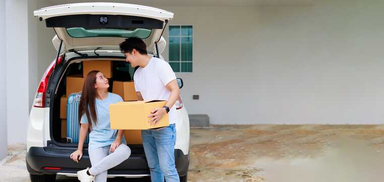 Happy Aisan Couple Help Moving Cardbord Boxes To New House Together. Moving Day.