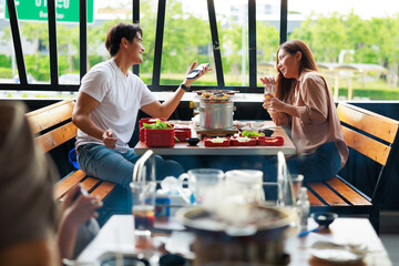 Romantic dating couple in love eating lunch together at grilled restaurant. - obrazy, fototapety, plakaty