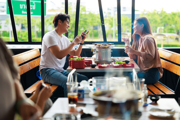 Romantic dating couple in love eating lunch together at grilled restaurant.