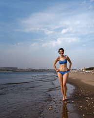 Girl in bikini walks on beach