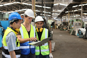 Architect men and worker standing and checking at heavy industry manufacturing factory with computer. Multiethnic business manager looking in future with warehouse factory building