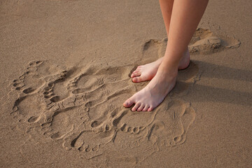 Fototapeta na wymiar Woman barefoot on sand