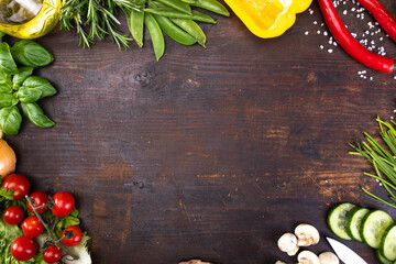 Fresh raw vegetable, herbs, on a rustic wood board. Healthy cooking composition, food frame, background with copy space.
