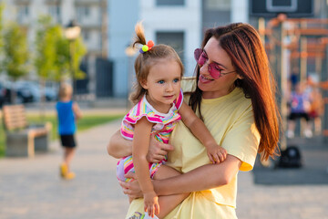 Toddler girl and mom. Family walk