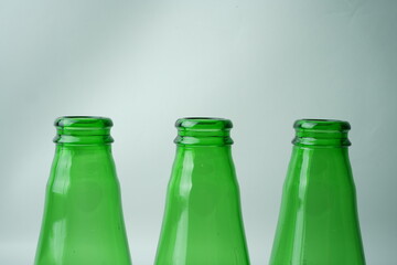 Glass bottles of soda on white background