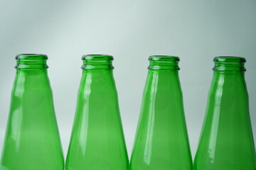Glass bottles of soda on white background
