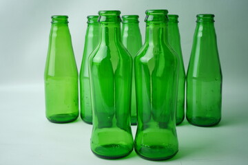 Glass bottles of soda on white background