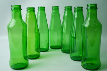 Glass bottles of soda on white background