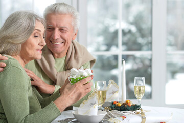 Beautiful elderly couple celebrating new year together 