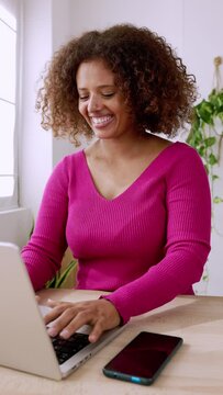 Young african woman using laptop at home. Happy multiracial teenager girl studying online. High quality 4k footage