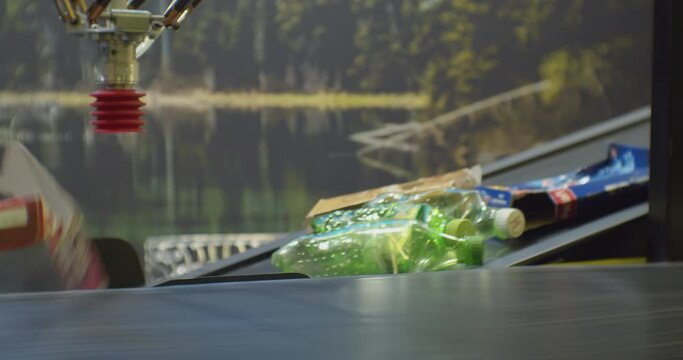 modern industrial processing of household waste.plastic bottles and paper packaging move along a sorting line conveyor at a recycling plant.close-up.