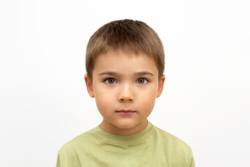 face of a child close-up on a white isolated background. portrait of a little boy 5 years old