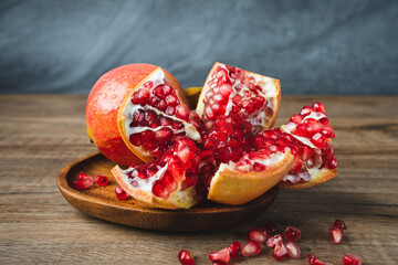 red pomegranate in the wood plate