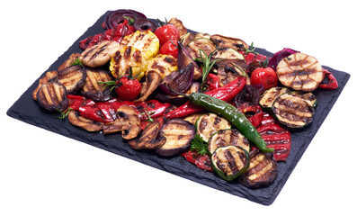 Grilled vegetables mix on a stone serving board - zucchini eggplant onions corn mushroom tomato