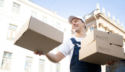 Courier delivery a male driver delivers orders in boxes to the house. Uniform and cap for an...