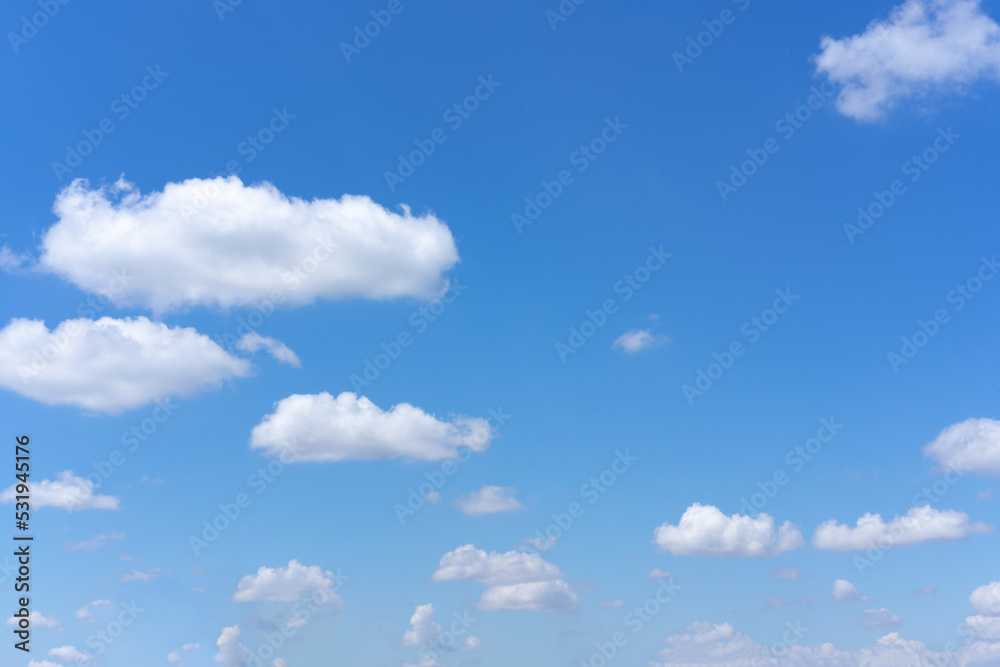Wall mural clear blue sky background with white clouds